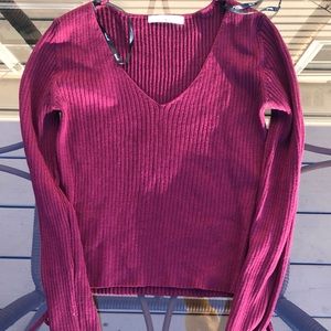 Long sleeved burgundy top.
